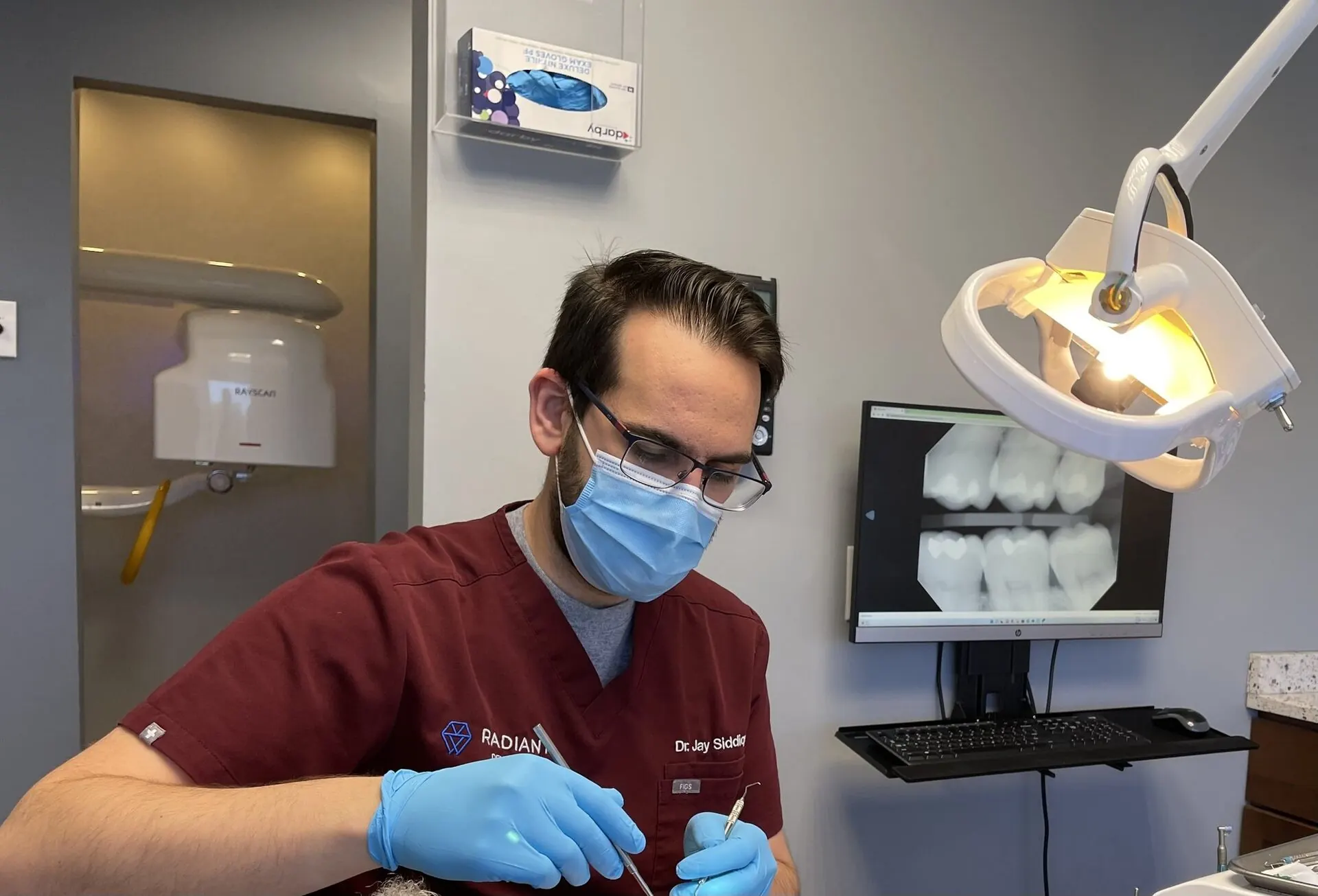 Dr. Jay Siddiqui, DDS at work in the operatory — Radiant Dental Care, Chevy Chase, MD